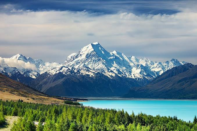 Snow-covered Aoraki Mount Cook rising above the turquoise water of Lake Pukaki in New Zealand