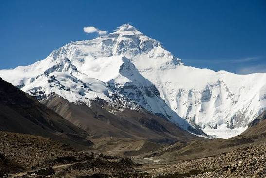 Mount Everest north face snow pyramid against deep blue Himalayan sky