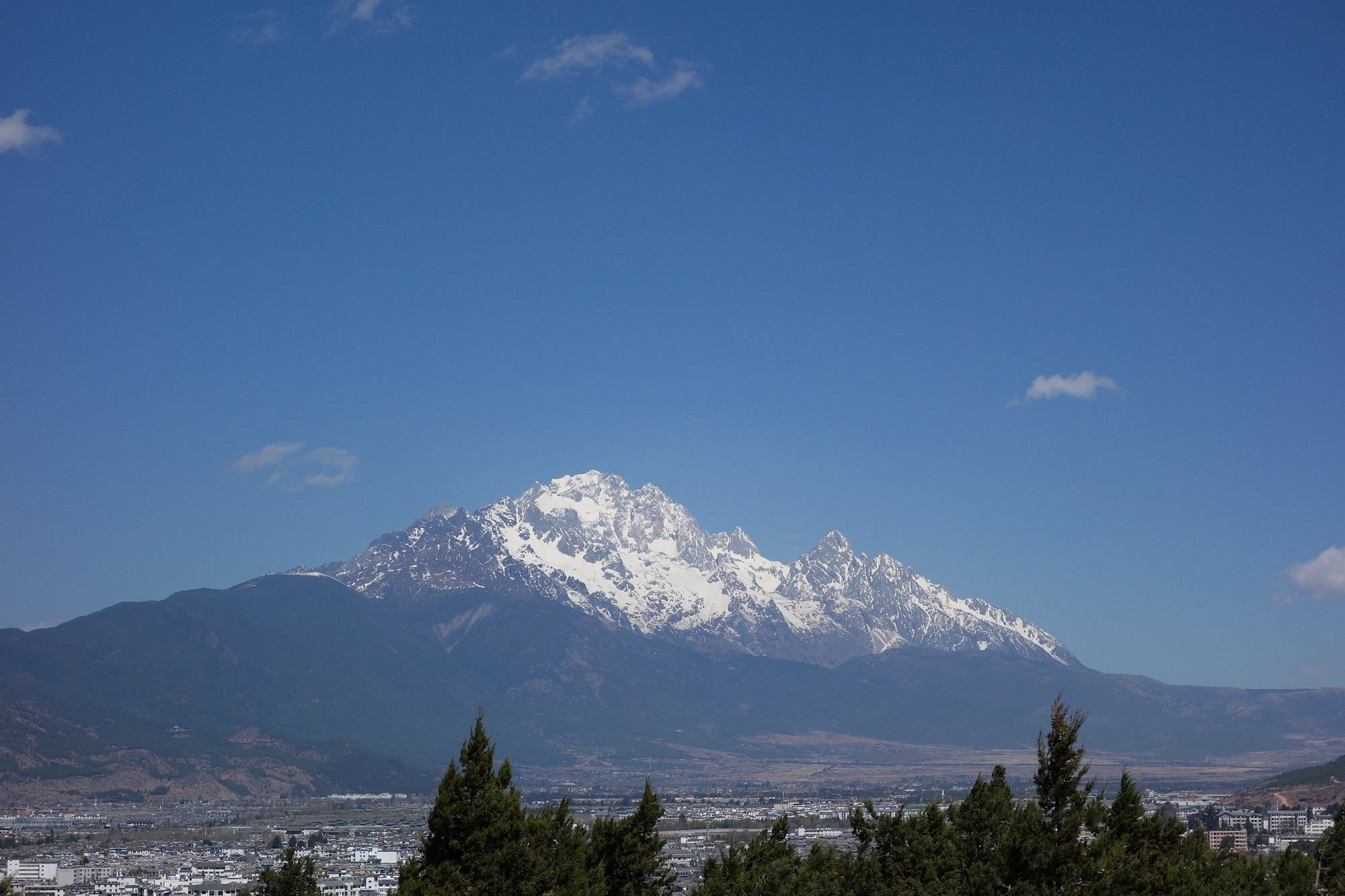 Yulong Snow Mountain range near Lijiang with dramatic peaks framed by low clouds